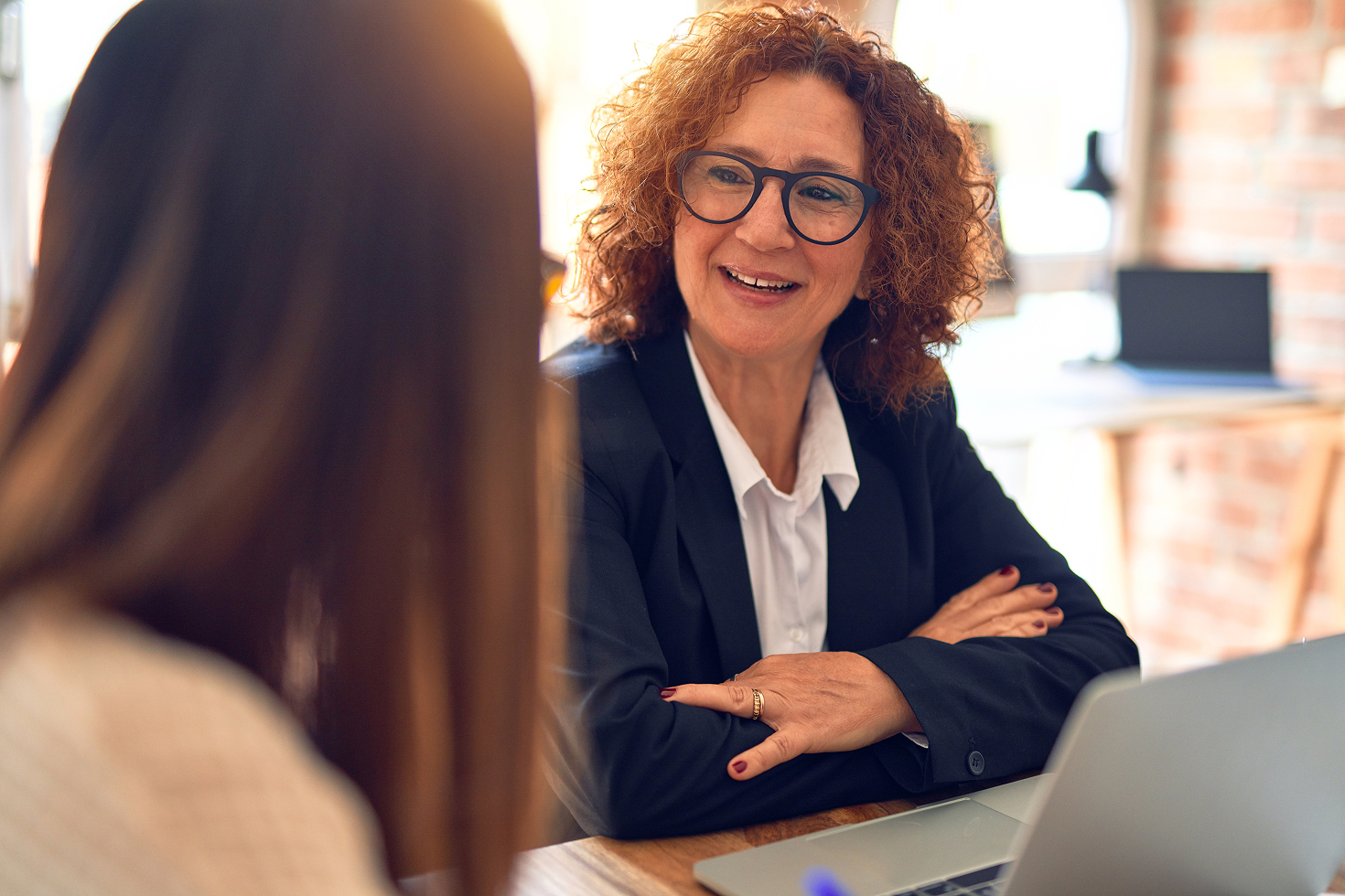 Female CEO with glasses talking to CRO about the current state of the channel