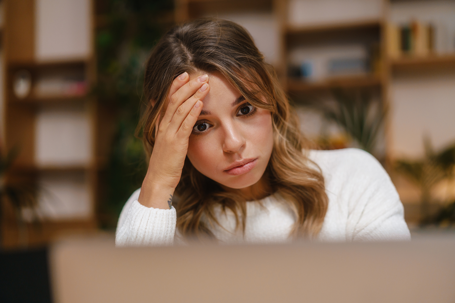 worried female channel leader looking at partner ai creations in horror.